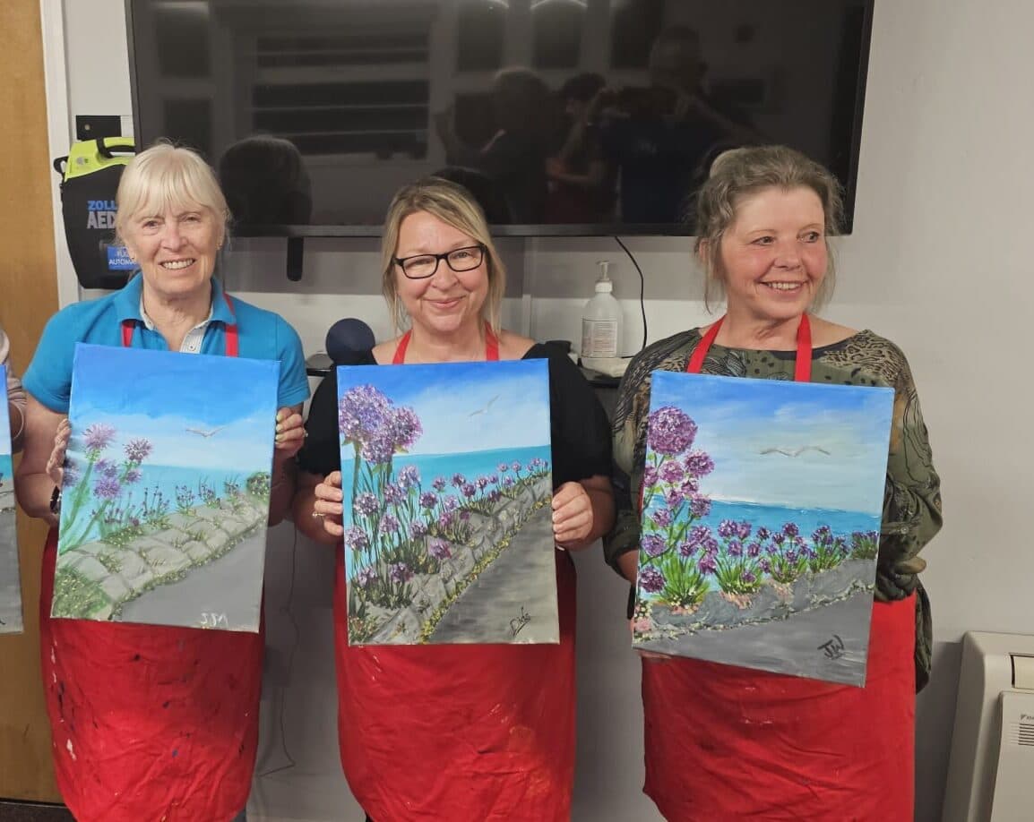 Janet and Dee with their paintings