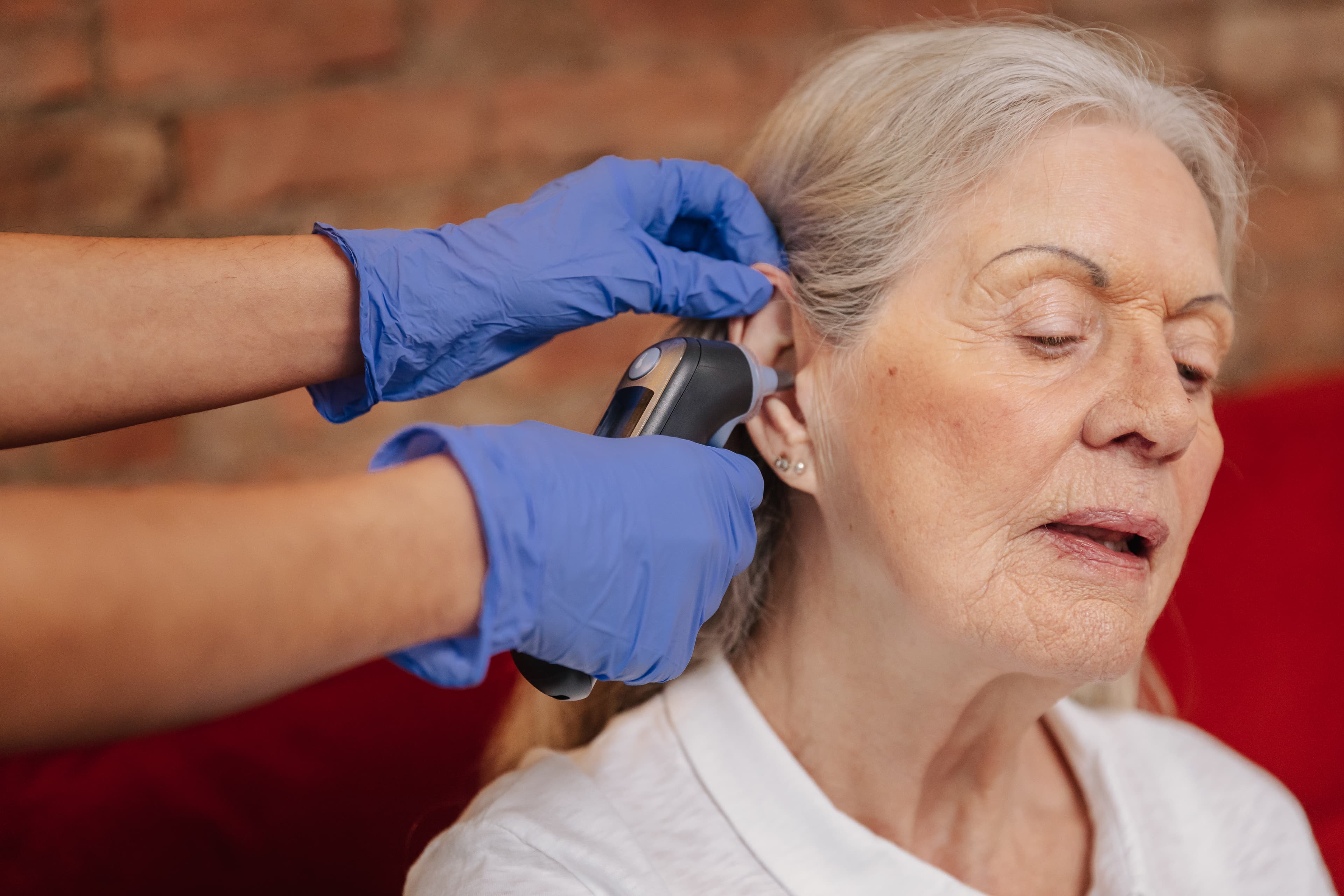 Home Instead Swansea Care Professional assisting client with vital signs monitoring during care call.