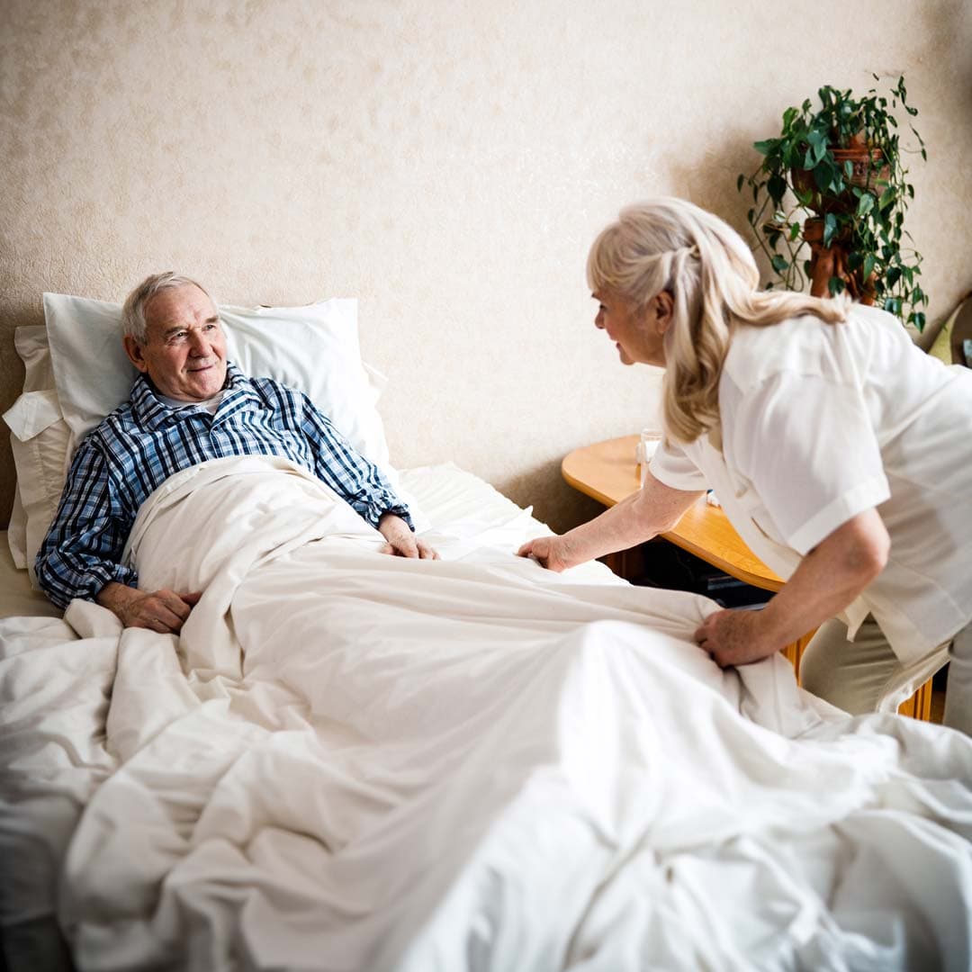 care professional supporting client get ready for bed for overnight care