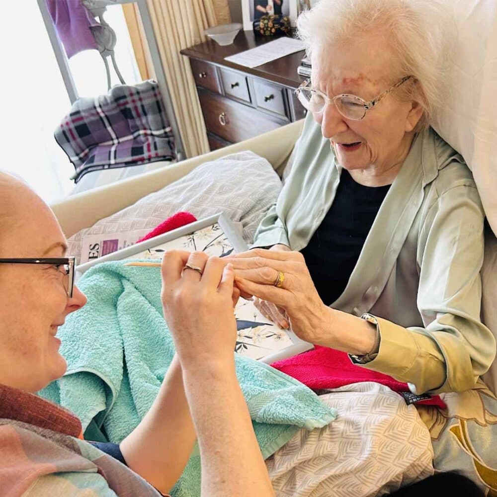 home instead client rosemary sitting enjoying at home nail care service