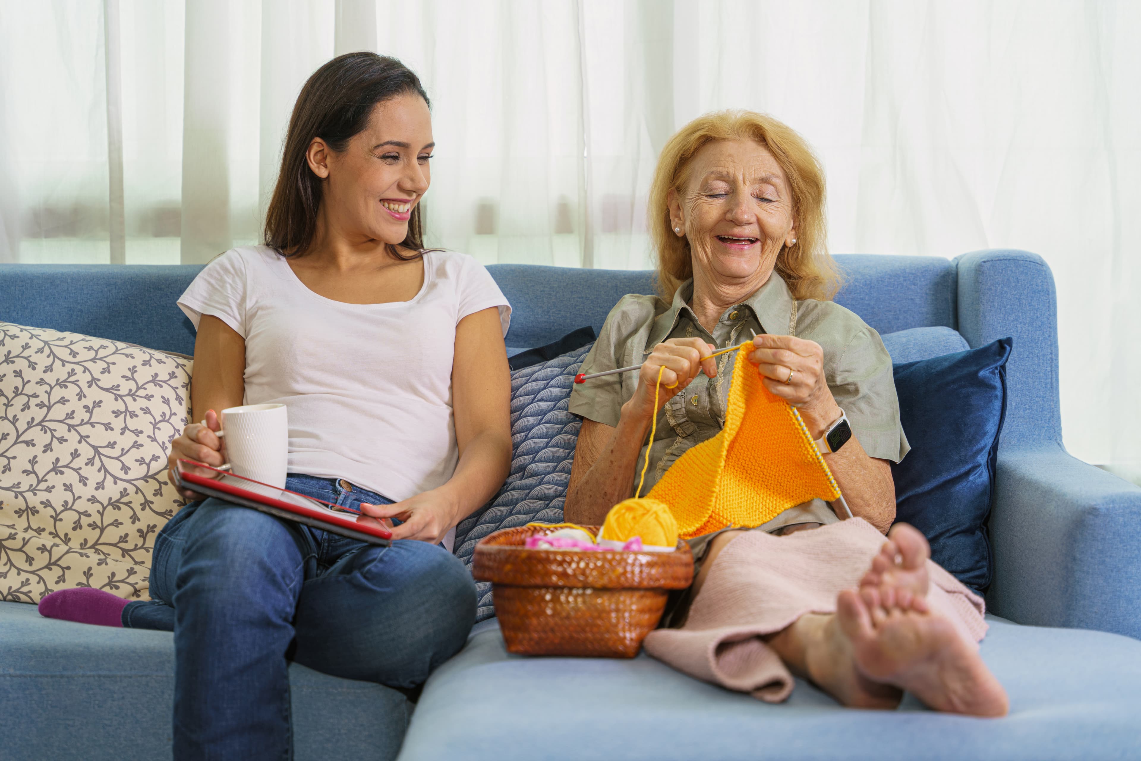 Home Instead Belbroughton Clent and Romsley Care Professional helps older lady with knitting