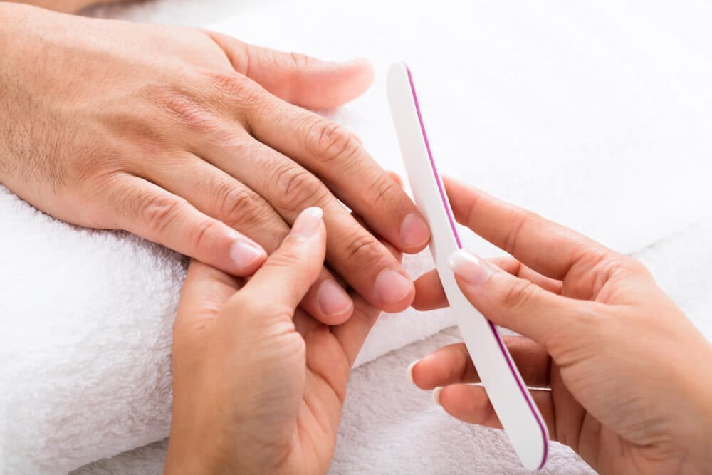 Care Professional providing nail care - Home Instead