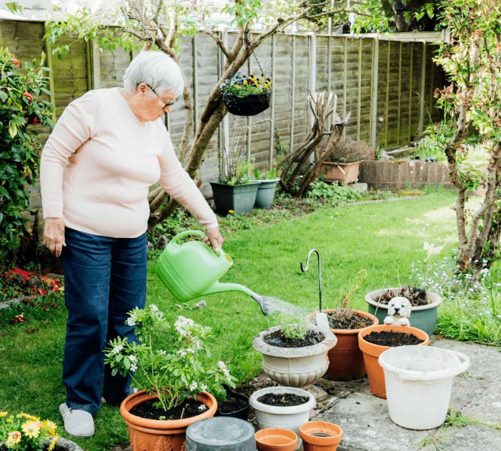 Home Instead Poole client watering flowers