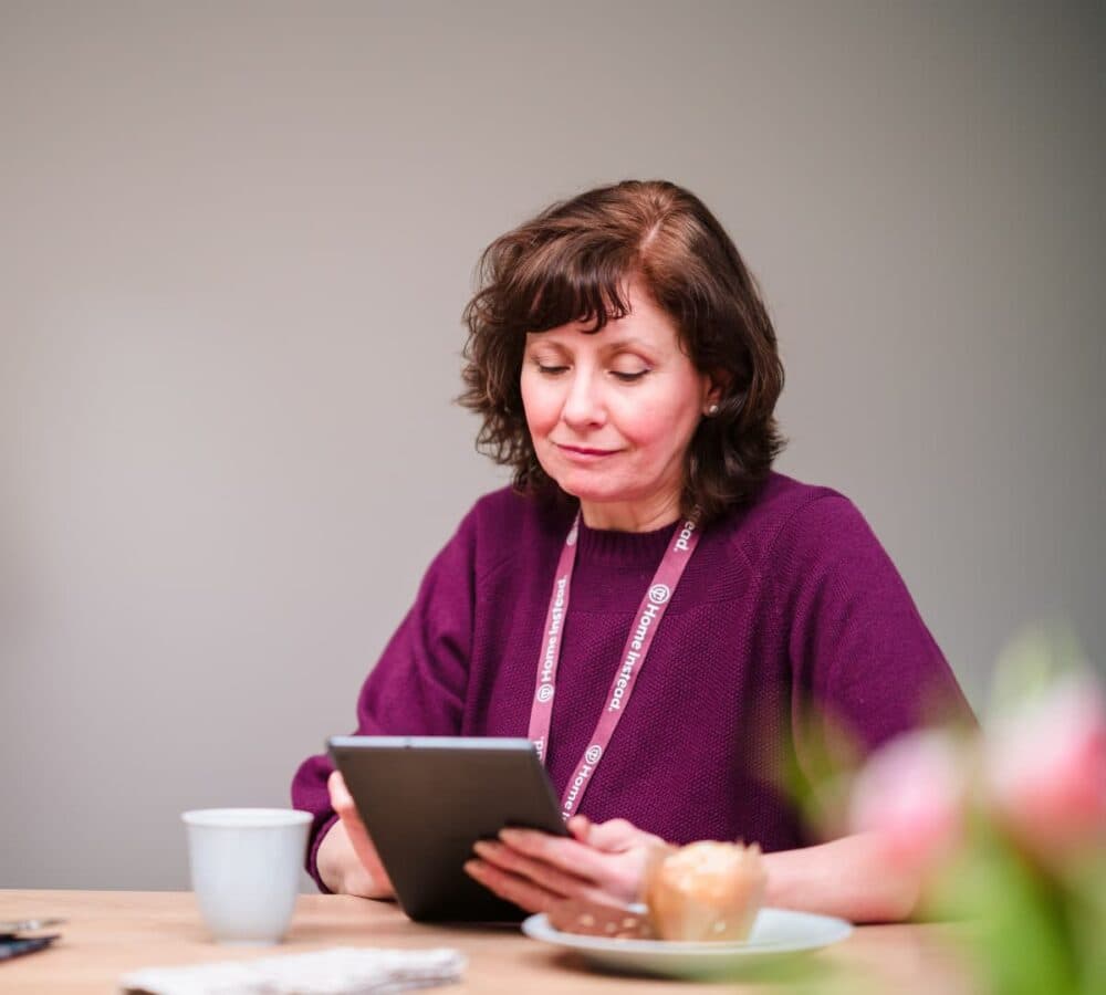 Home Instead Southampton Care Professional using tablet