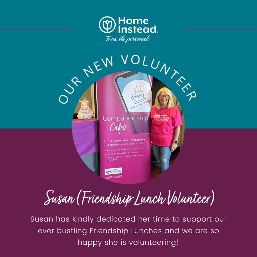 A woman stands in front of a sign, wearing a pink shirt, announced as a new volunteer at Home Instead. - Home Instead