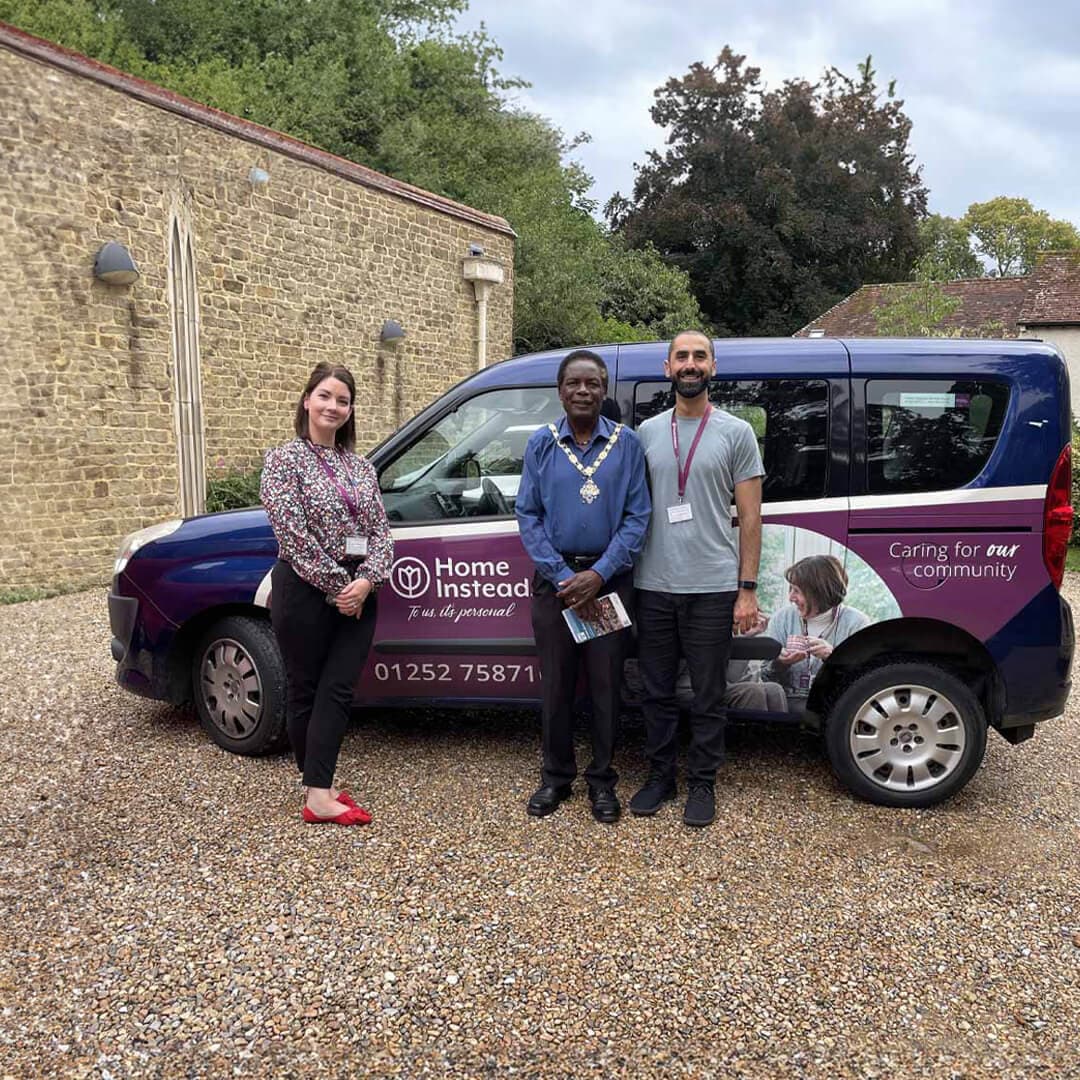 mahdi, lauren and Mayor Brodie Mauluka standing proudly in front of Home Instead's wheelchair accessible vehicle.