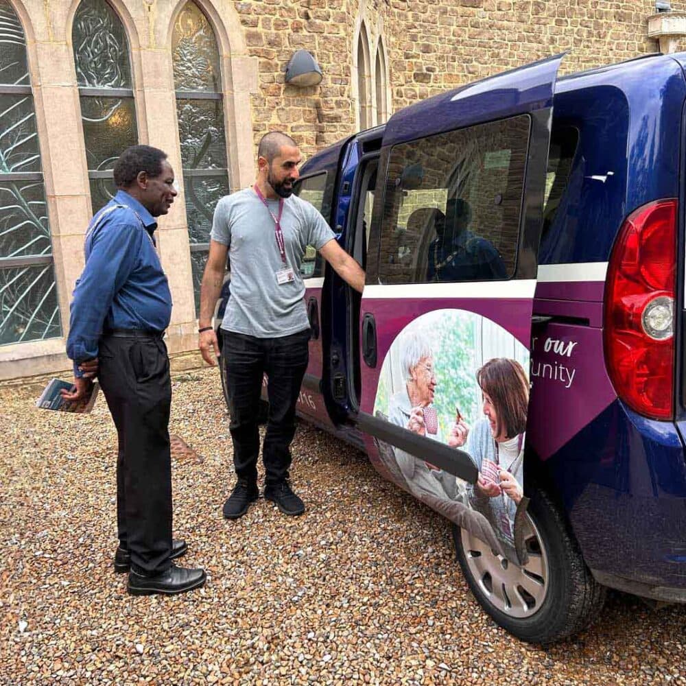 Home Instead Farnham's Director of Care Mahdi showing the Mayor their wheelchair accessible vehicle