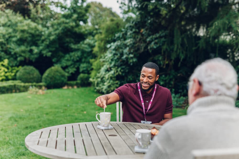 Care Professional drinking with client - Home Instead