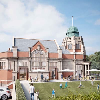 Children playing in front of a large brick building with arched windows and a tower. - Home Instead