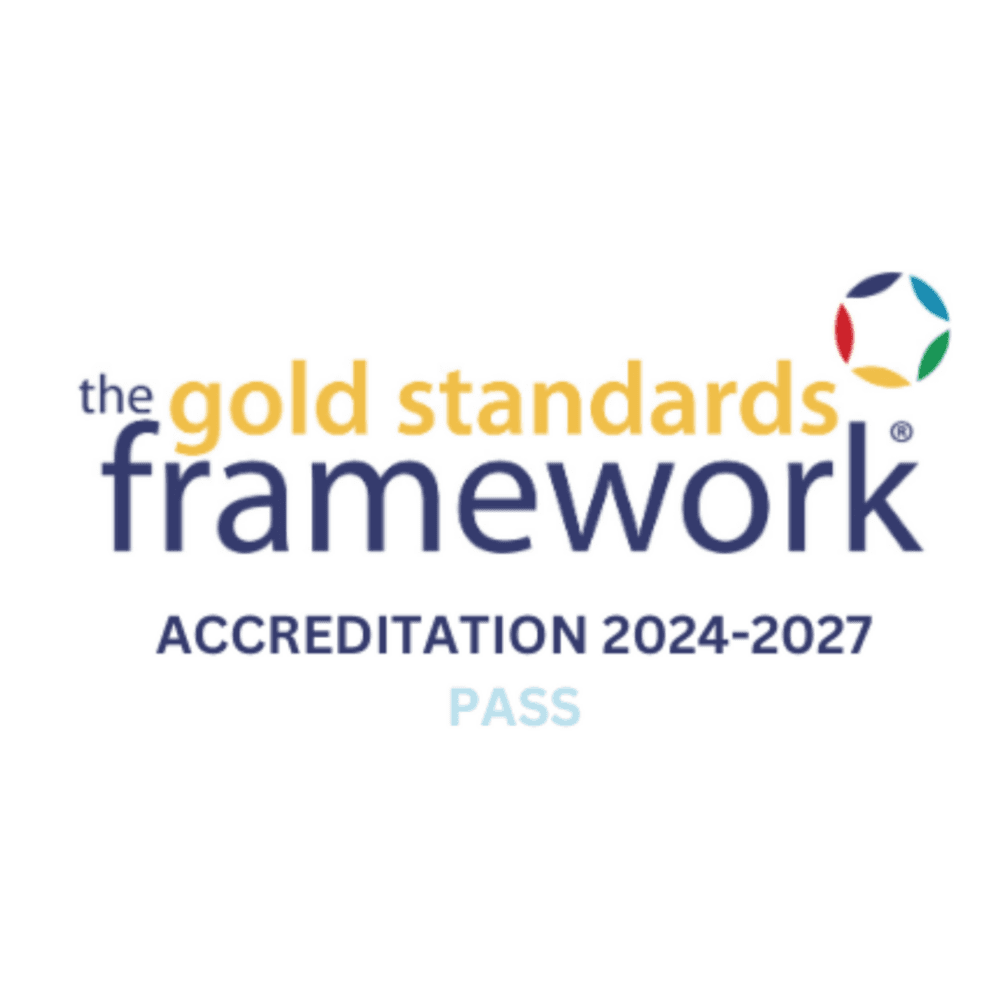 Smiling woman and man standing together in front of a solid purple background. - Home Instead