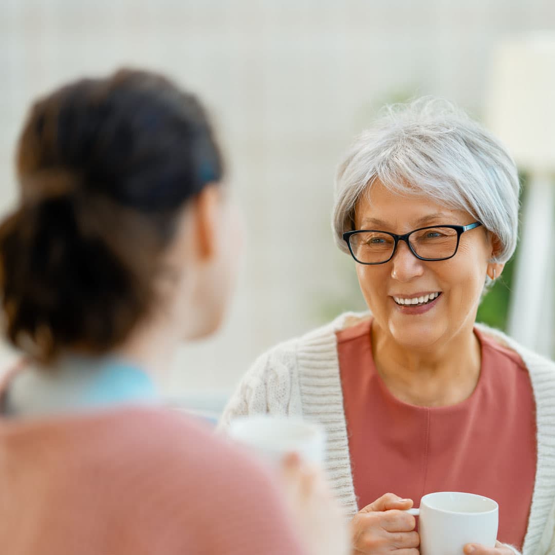 daughter chatting with her elderly Mum about home care options