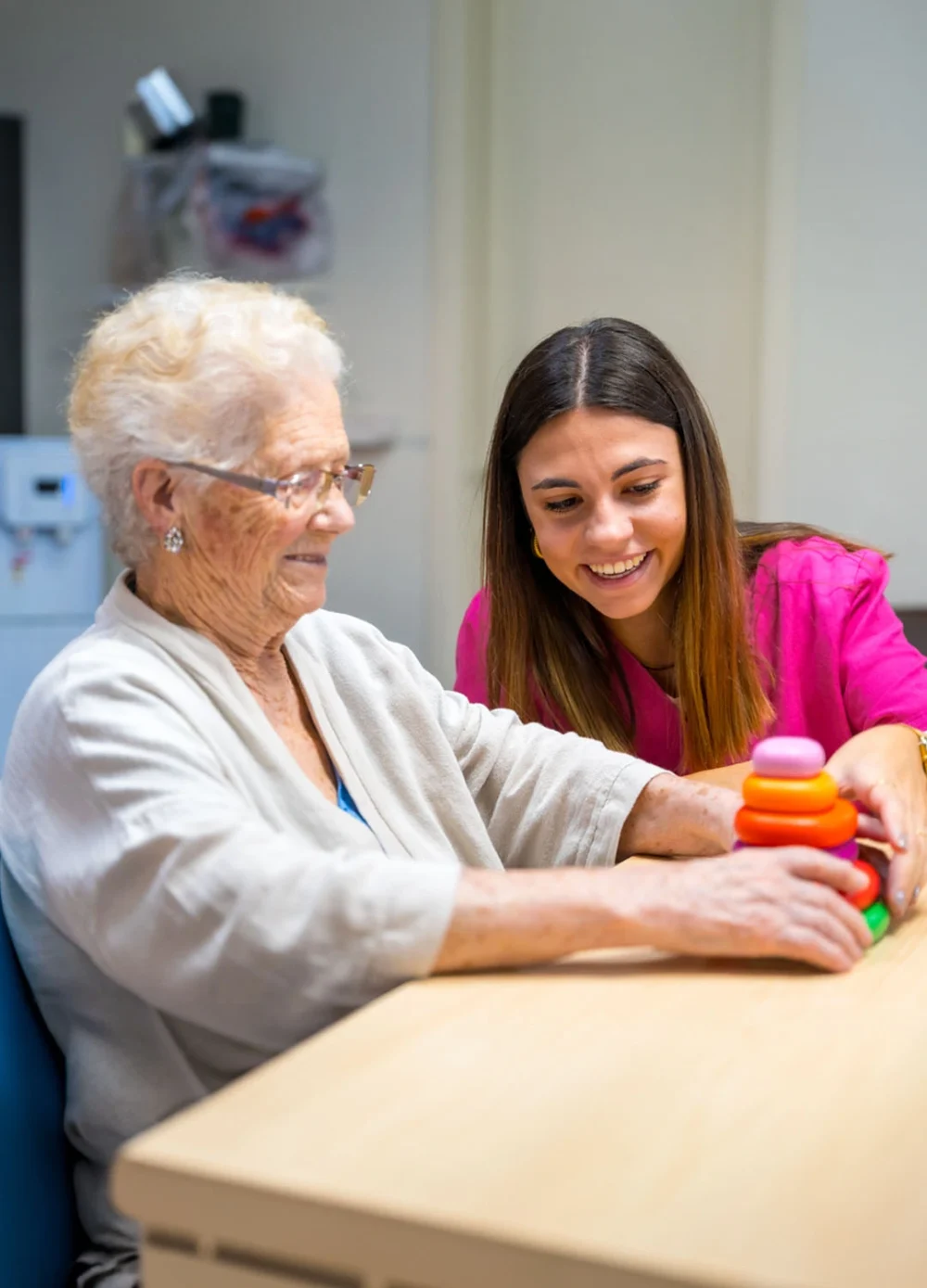 care professional supporting her client with brain training exercises
