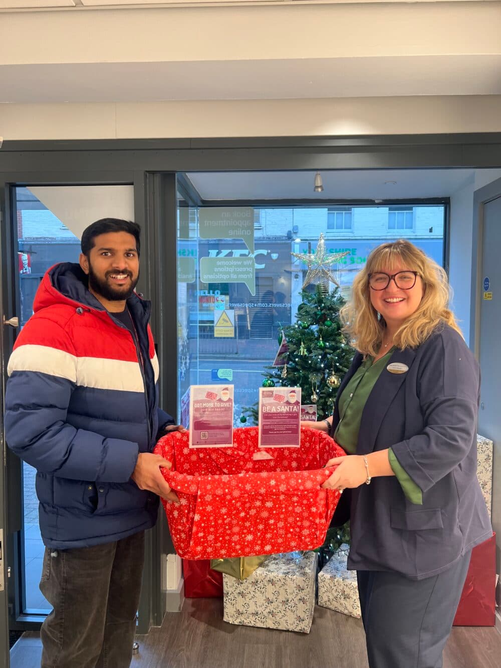 Jinson, our marketing coordinator receiving the basket from Specsavers manager.