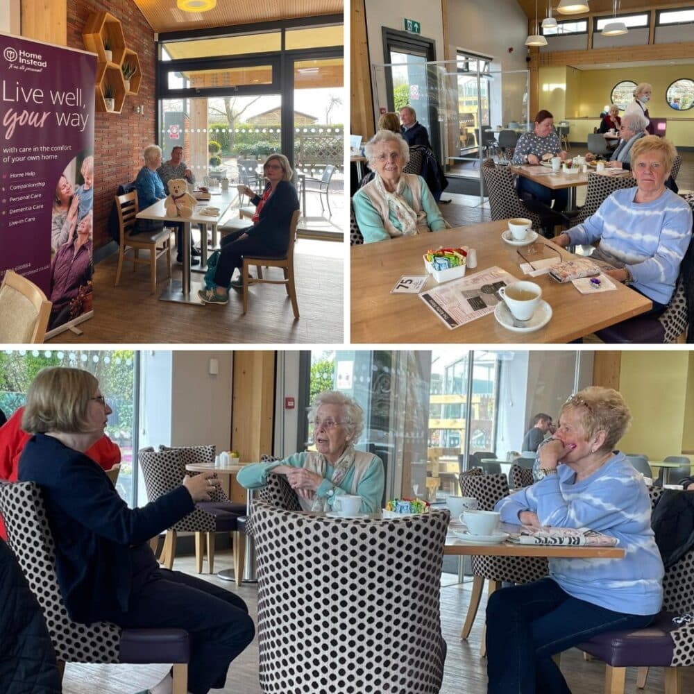 Older adults enjoying drinks and conversation in a bright, cozy café with large windows and modern decor. - Home Instead
