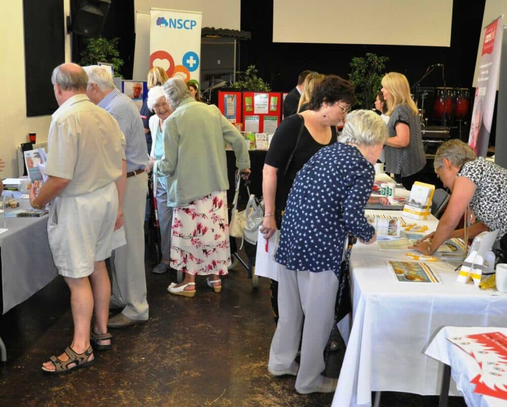 A group of people standing in a room. - Home Instead