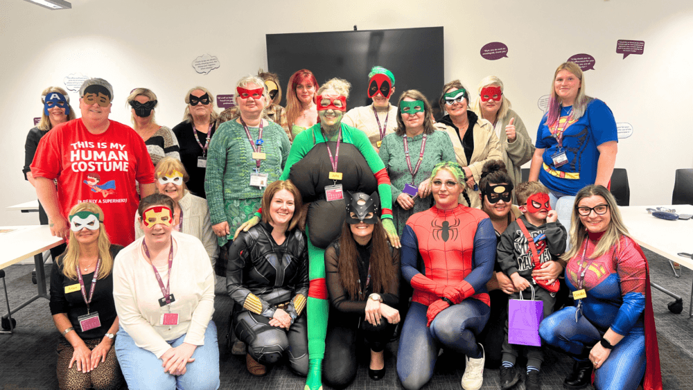 group photo in which office team wearing super hero costume