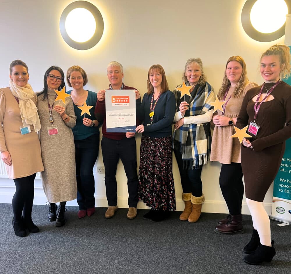 HomeInstead Yeovil 5 Star employer Award team photo, team holding the award certificate and 5 stars.