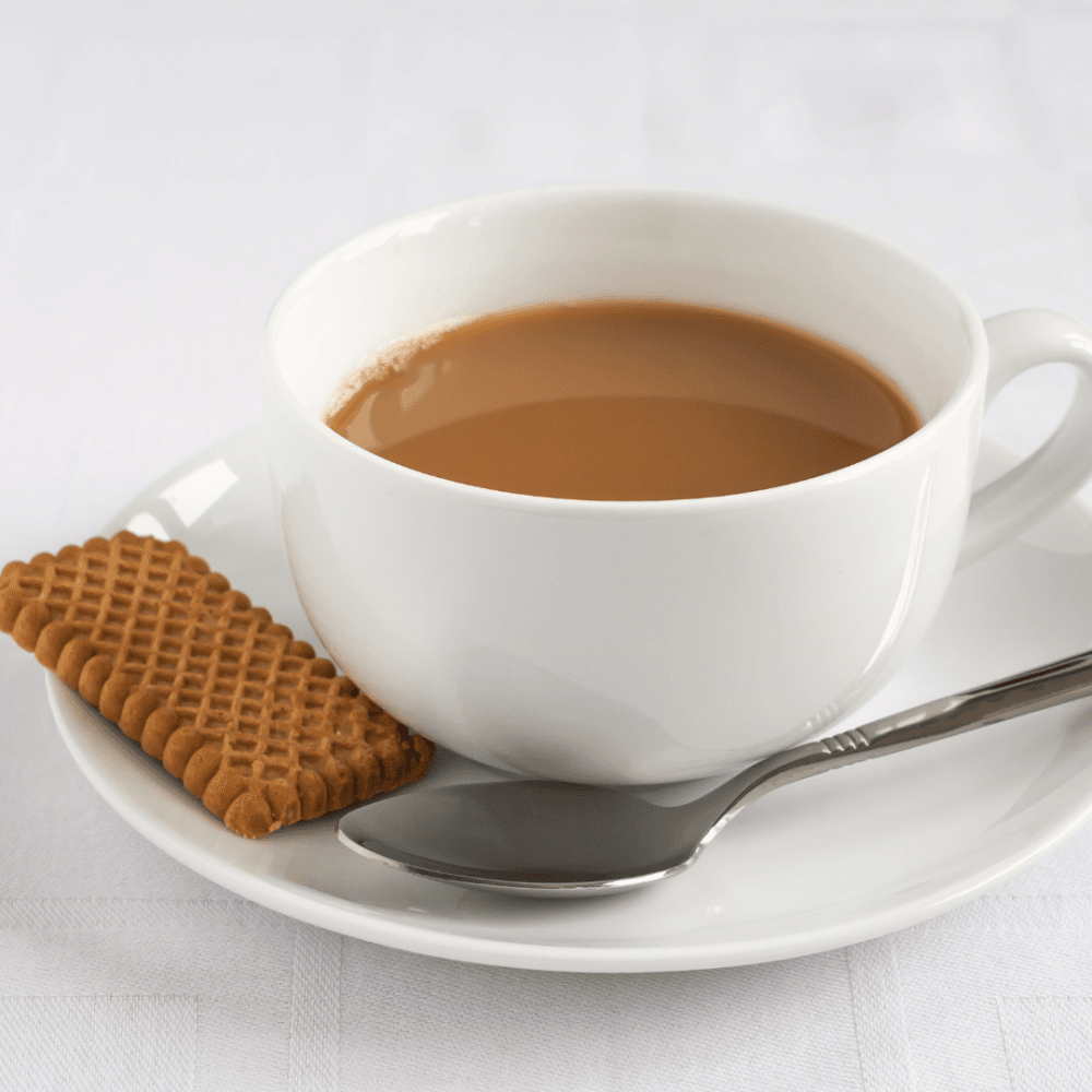 A cup of tea with milk on a white saucer, a biscuit, and a spoon on a white tablecloth. - Home Instead