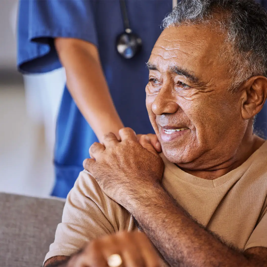 Senior man being comforted by doctor at a hospital