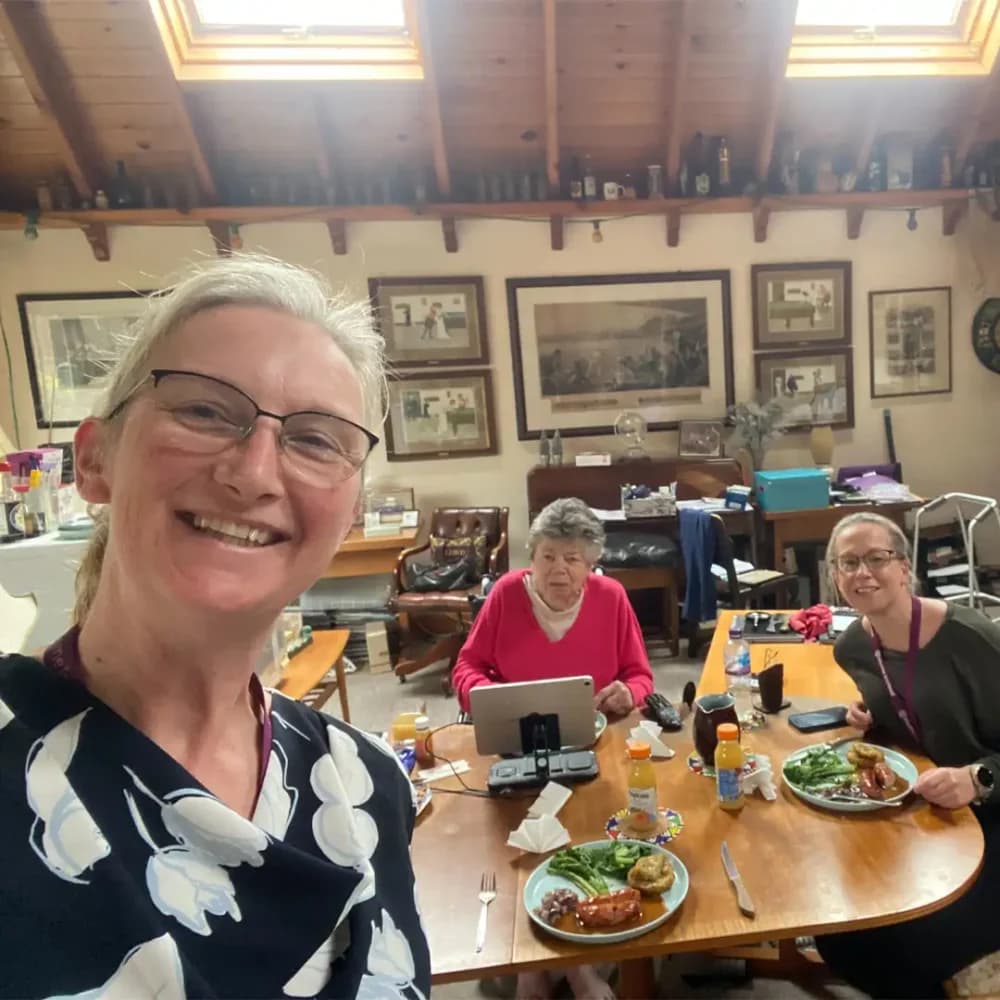 Home Instead Ascot Care Professional Jen enjoying a home cooked meal with her client