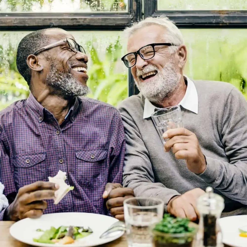 Home Instead Care Professional enjoying a meal with his client