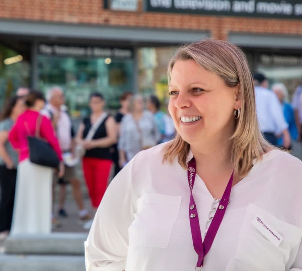 Happy woman smiling with short hair and wearing an ID