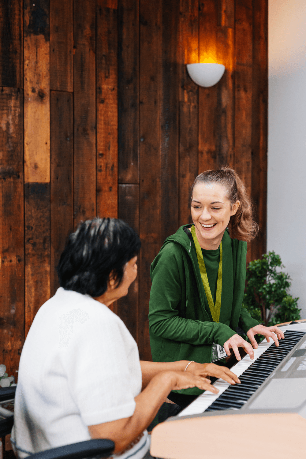 Care pro playing piano and client enjoying