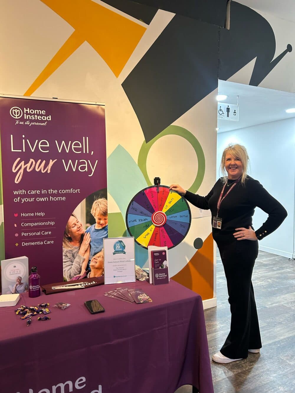 Home Instead employee at an information stall