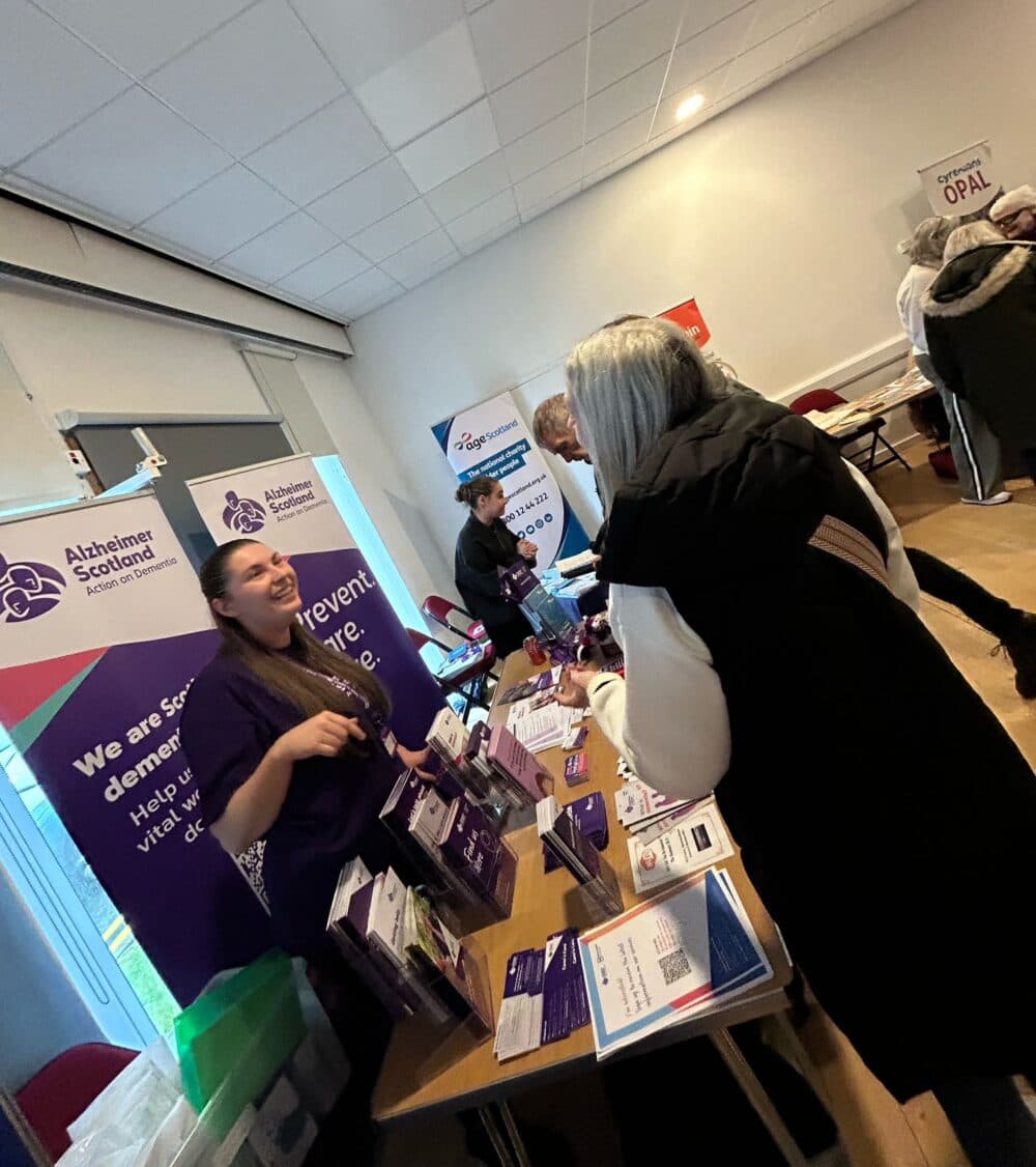 Person talking to an Alzheimer Scotland representative at the Older People Providers Fayre