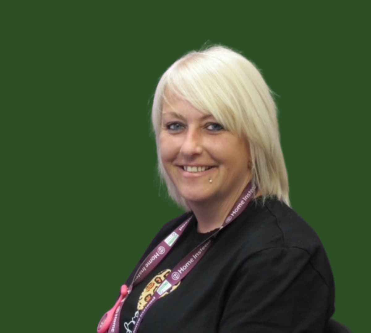 A woman with short hair and wearing black happy and smiling