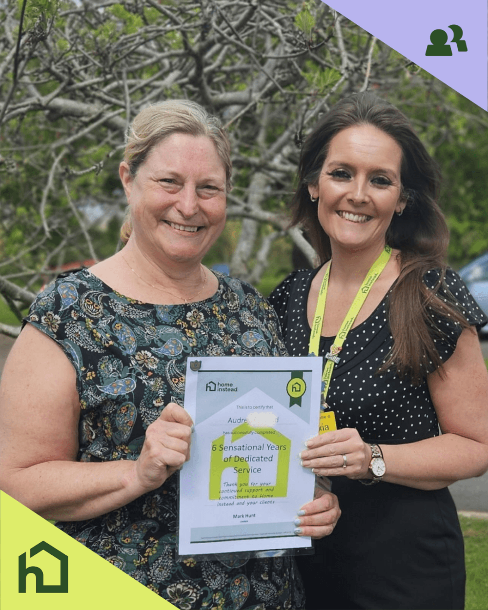 Care pro receiving anniversary certificate from deputy care manager