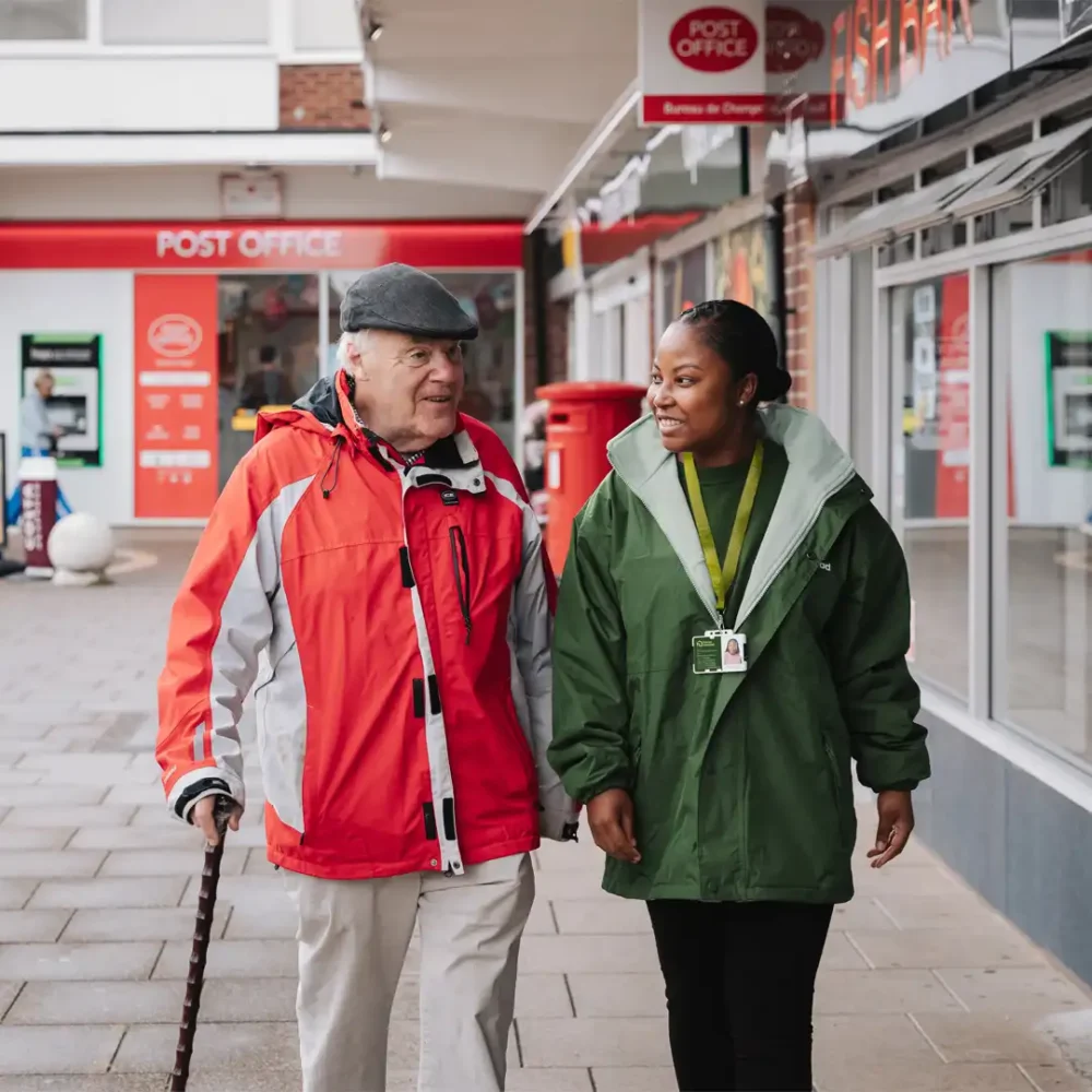 Home Instead Care Pro supporting her client on a trip to the local post office