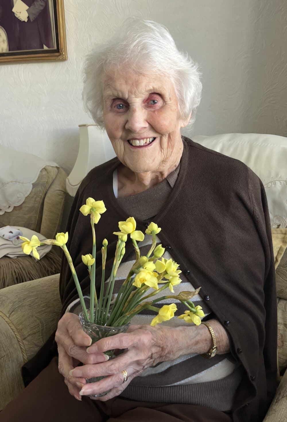 Home Care with Home Instead Client holding flowers
