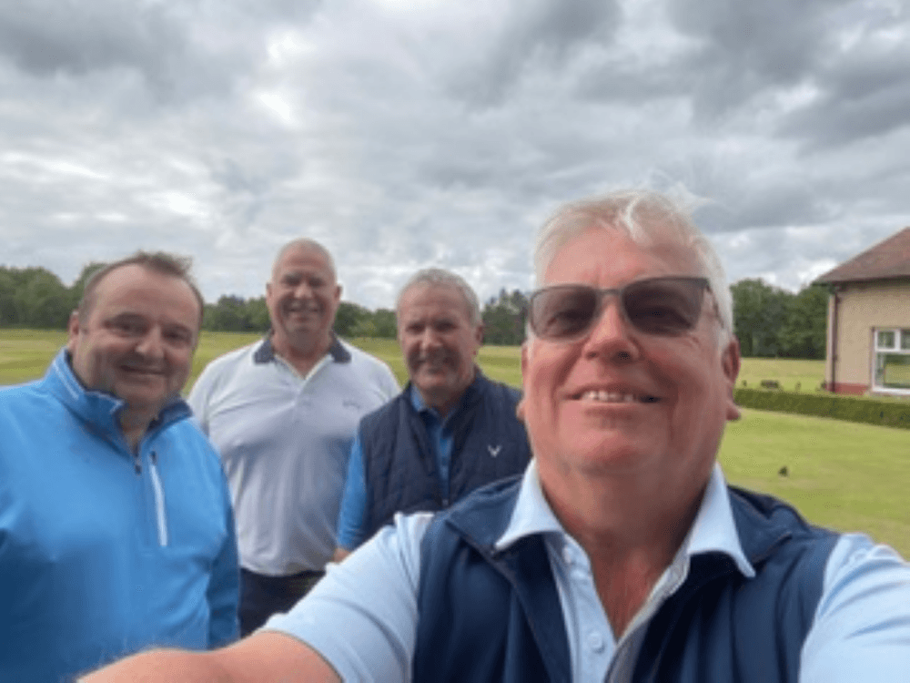 Image showing 4 Men in golf outfits, with dark cloudy sky and in the countryside