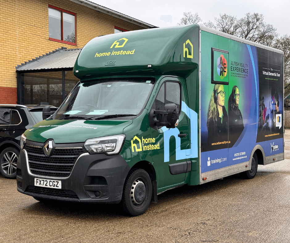 Green Home Instead Renault van with Autism and Dementia training visuals and branding