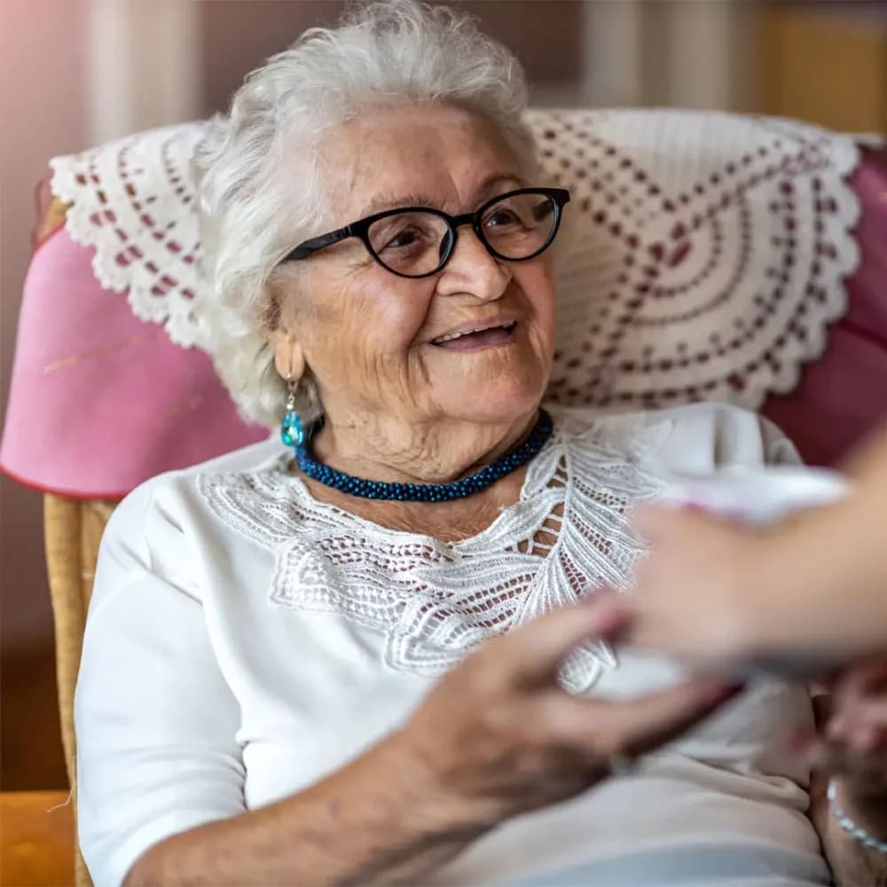 senior lady being passed a cup of tea, enjoying independence at home