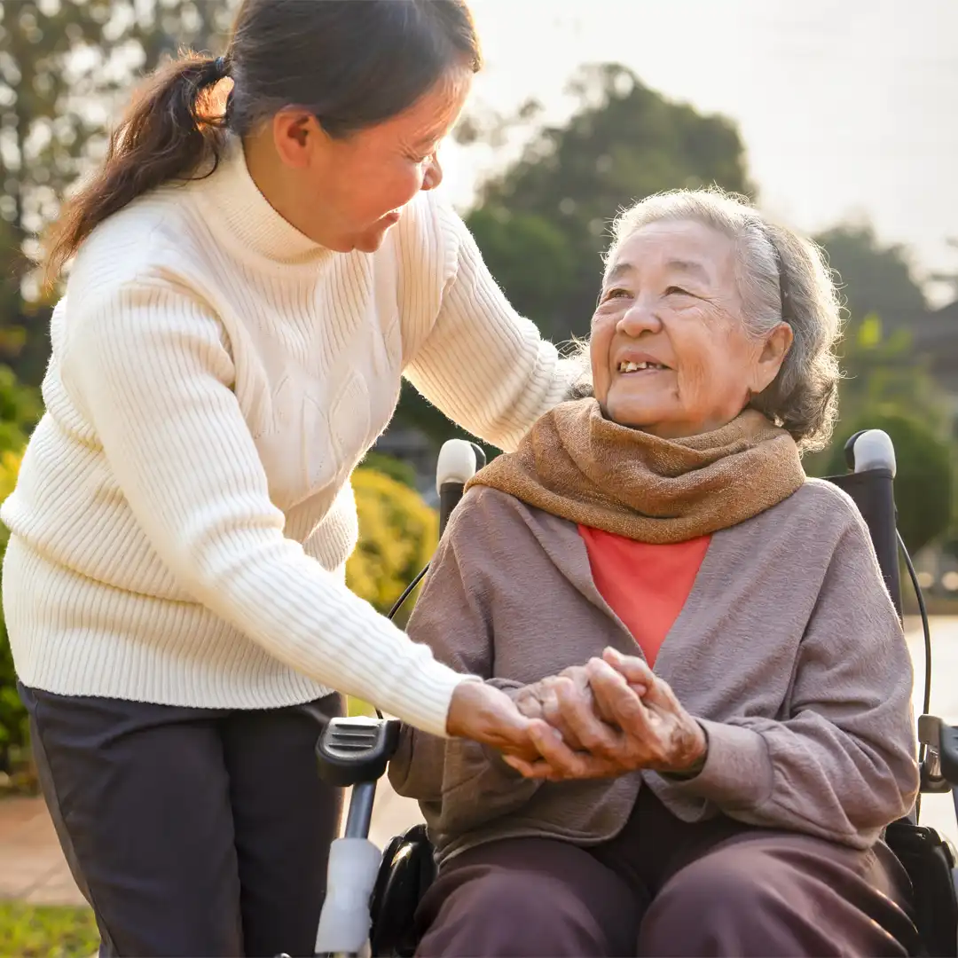 Asian daughter supporting her senior mum