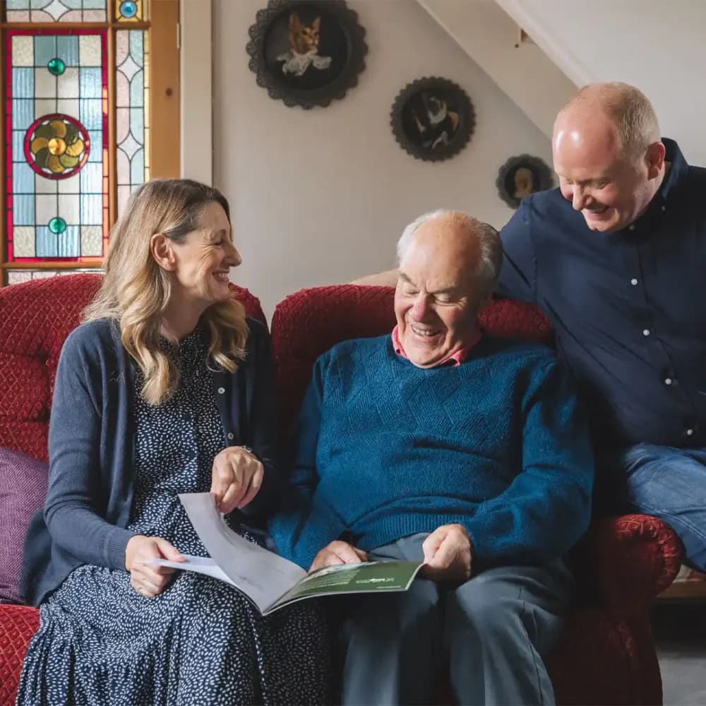 Elderly man discussing care with his family and home instead care manager