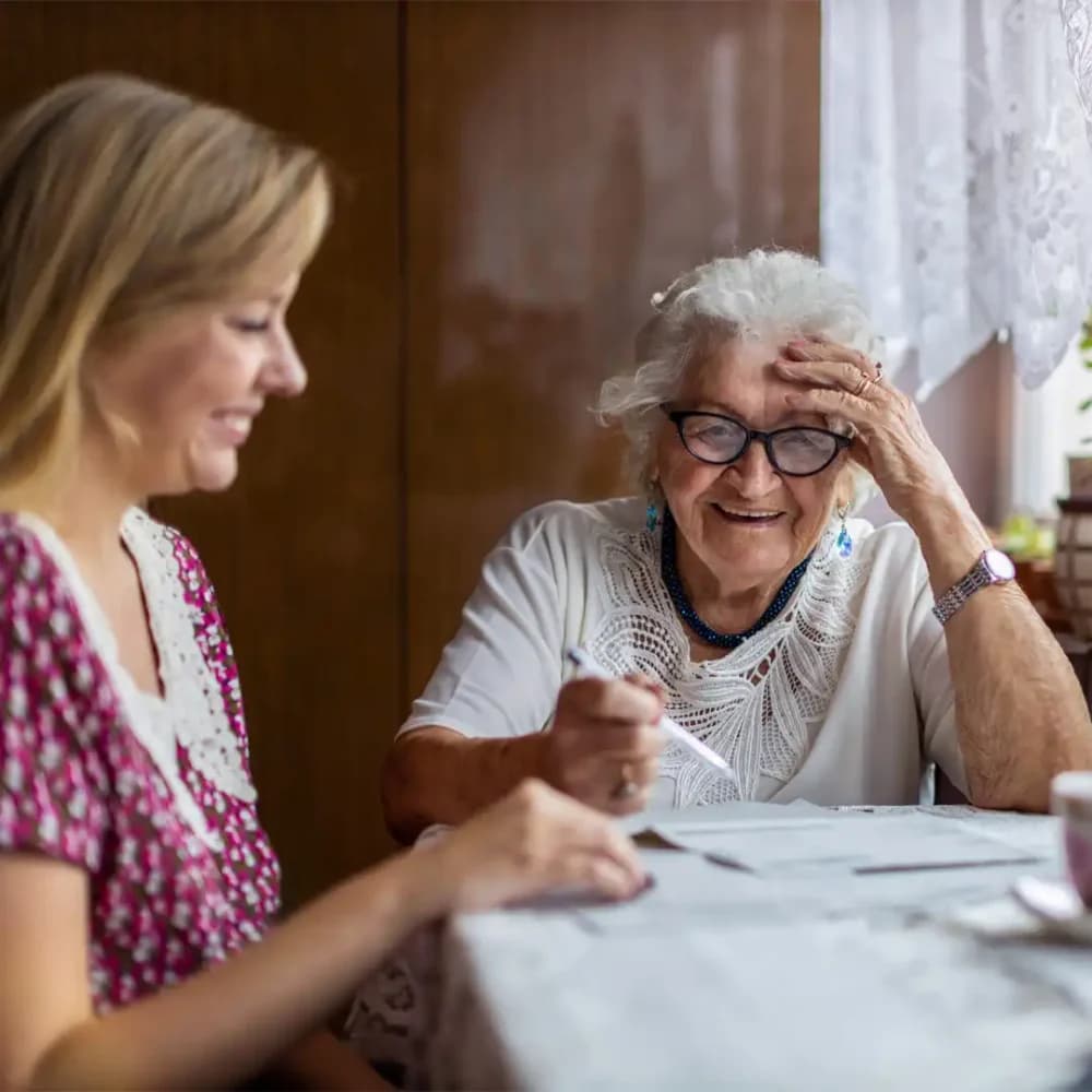 Senior lady reviewing home care resources with her daughter