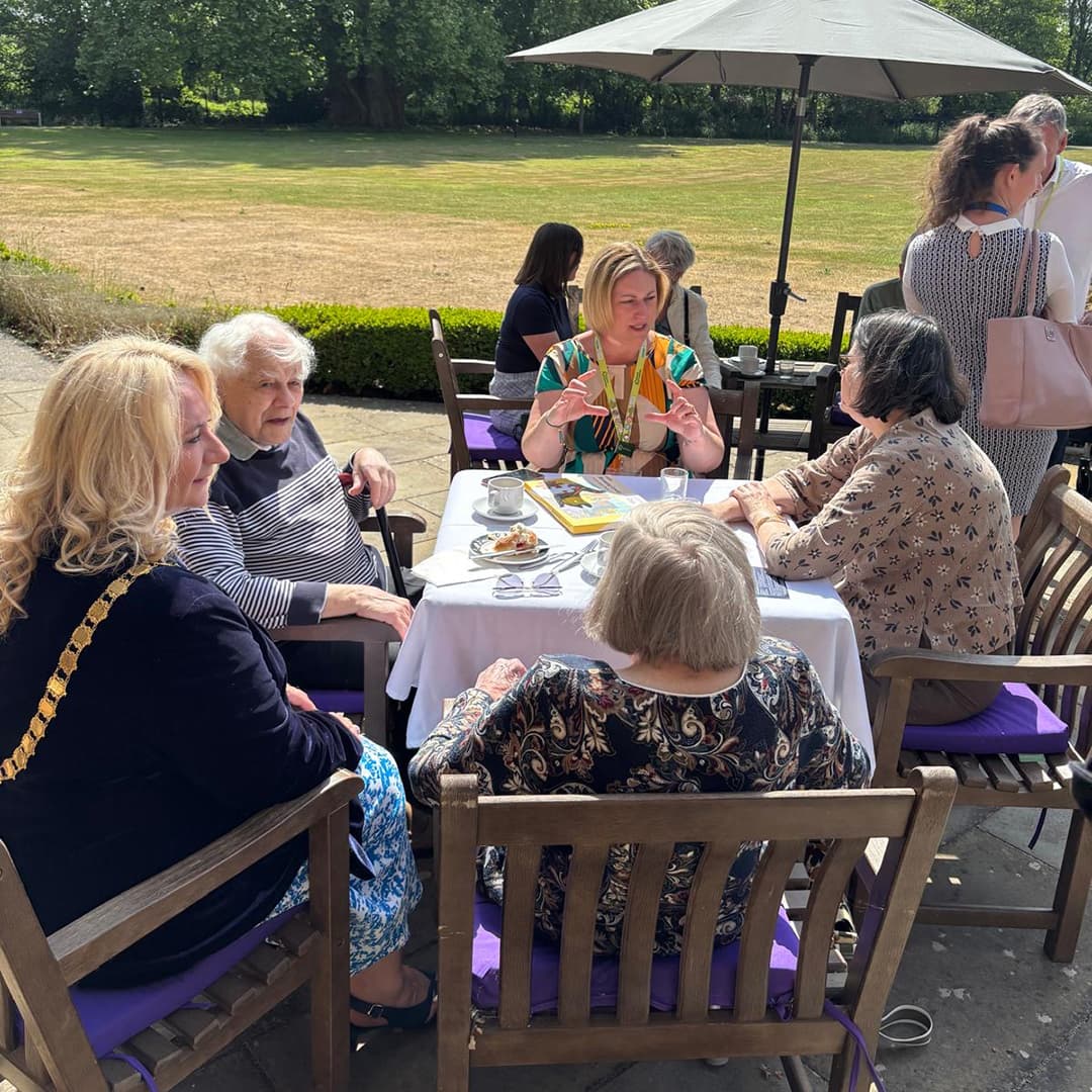 A full table of guests at the Connection Cafe at West Hall. Including the Mayor, Operations Manager at Home Instead and 2 female guests and 1 male.