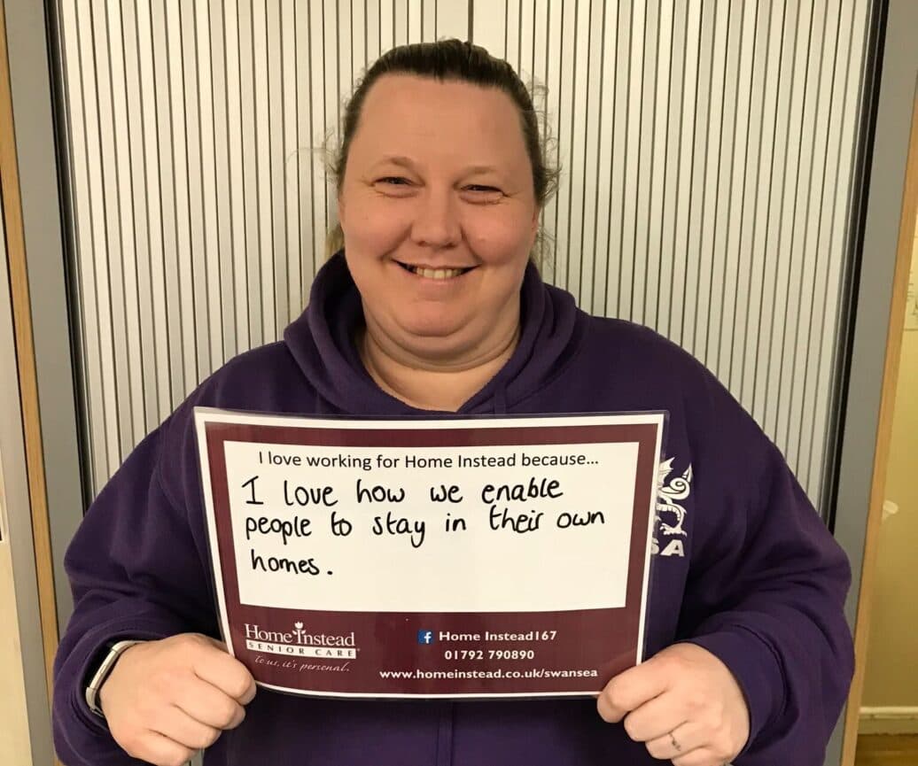 woman holding paper with words on