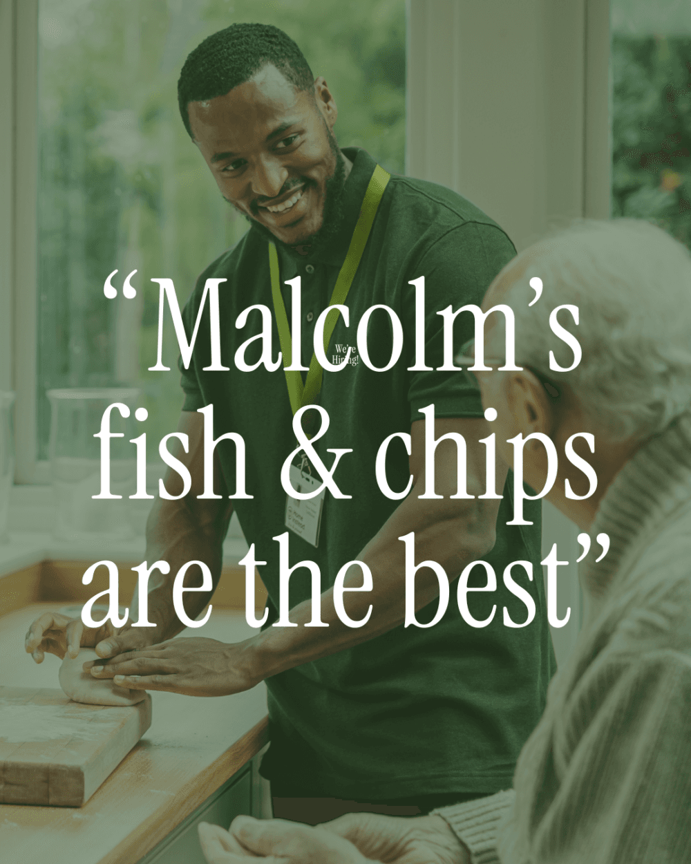 A caregiver smiles while helping an elderly man in a kitchen, with text praising Malcolm’s fish and chips. - Home Instead
