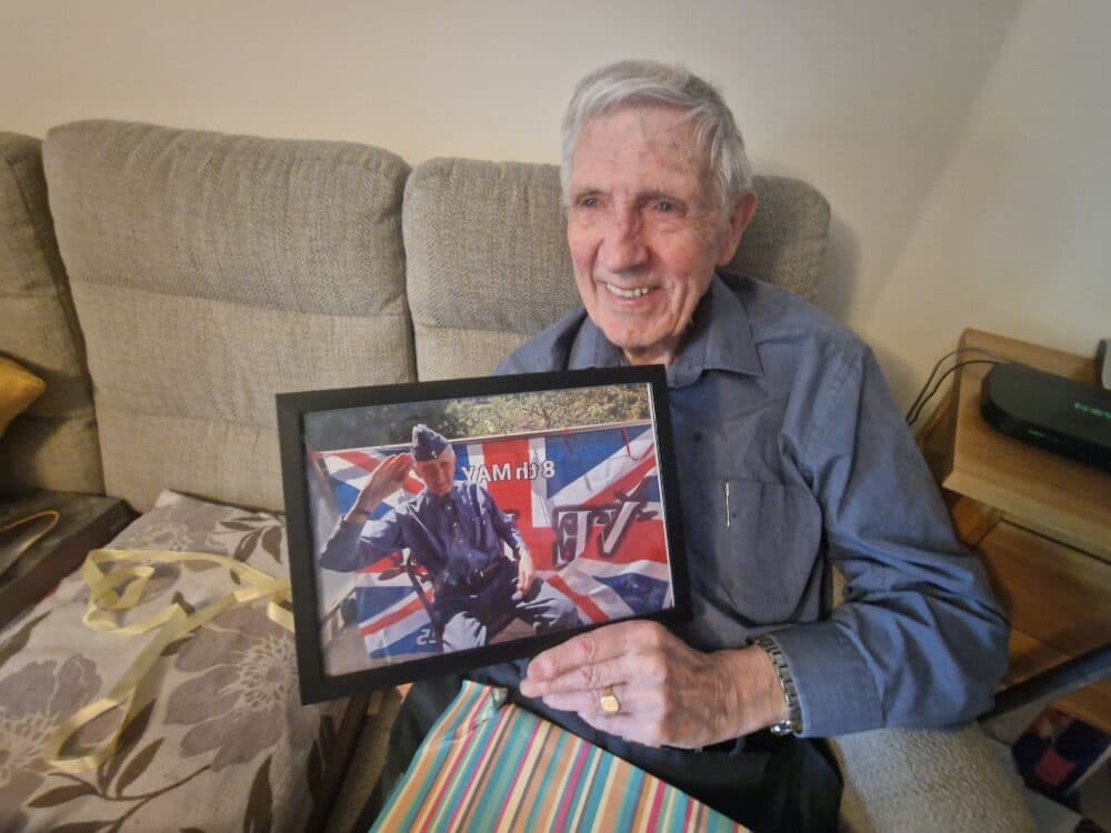 male client holding his VE Day celebration photo