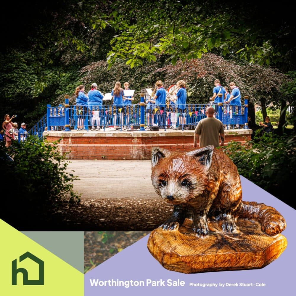 A group of musicians play on a park bandstand, with a red panda sculpture in the foreground. - Home Instead
