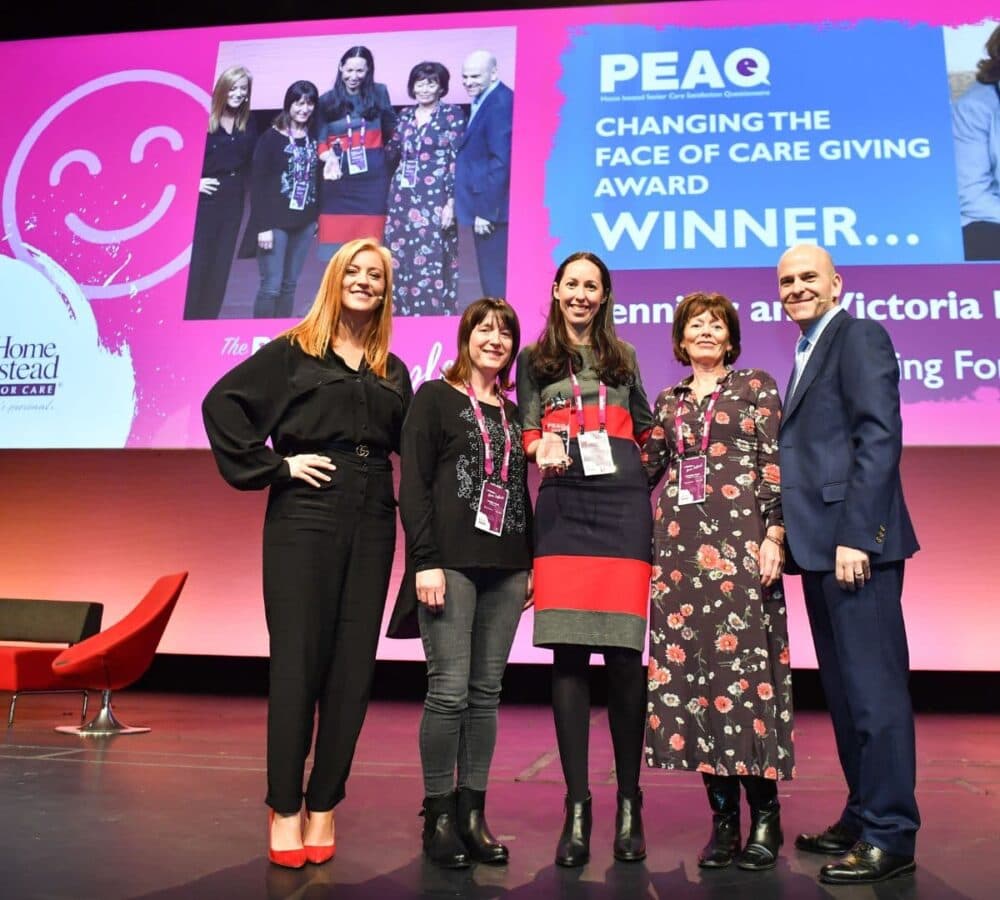 Group of people receiving an award at the stage