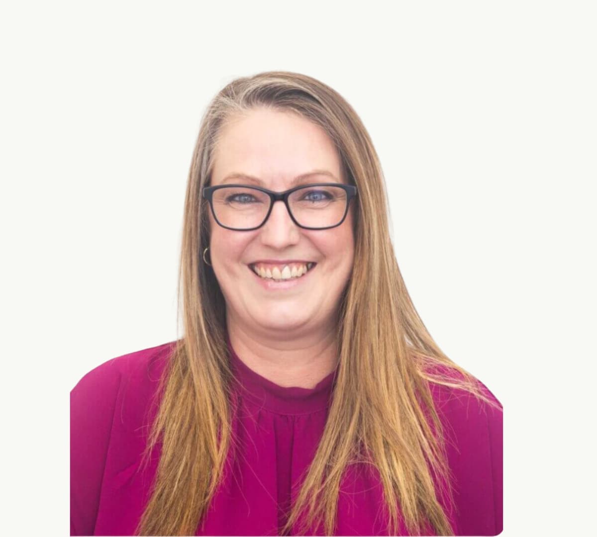 A woman with long blonde hair wearing eyeglasses and wearing dark pink smiling and happy