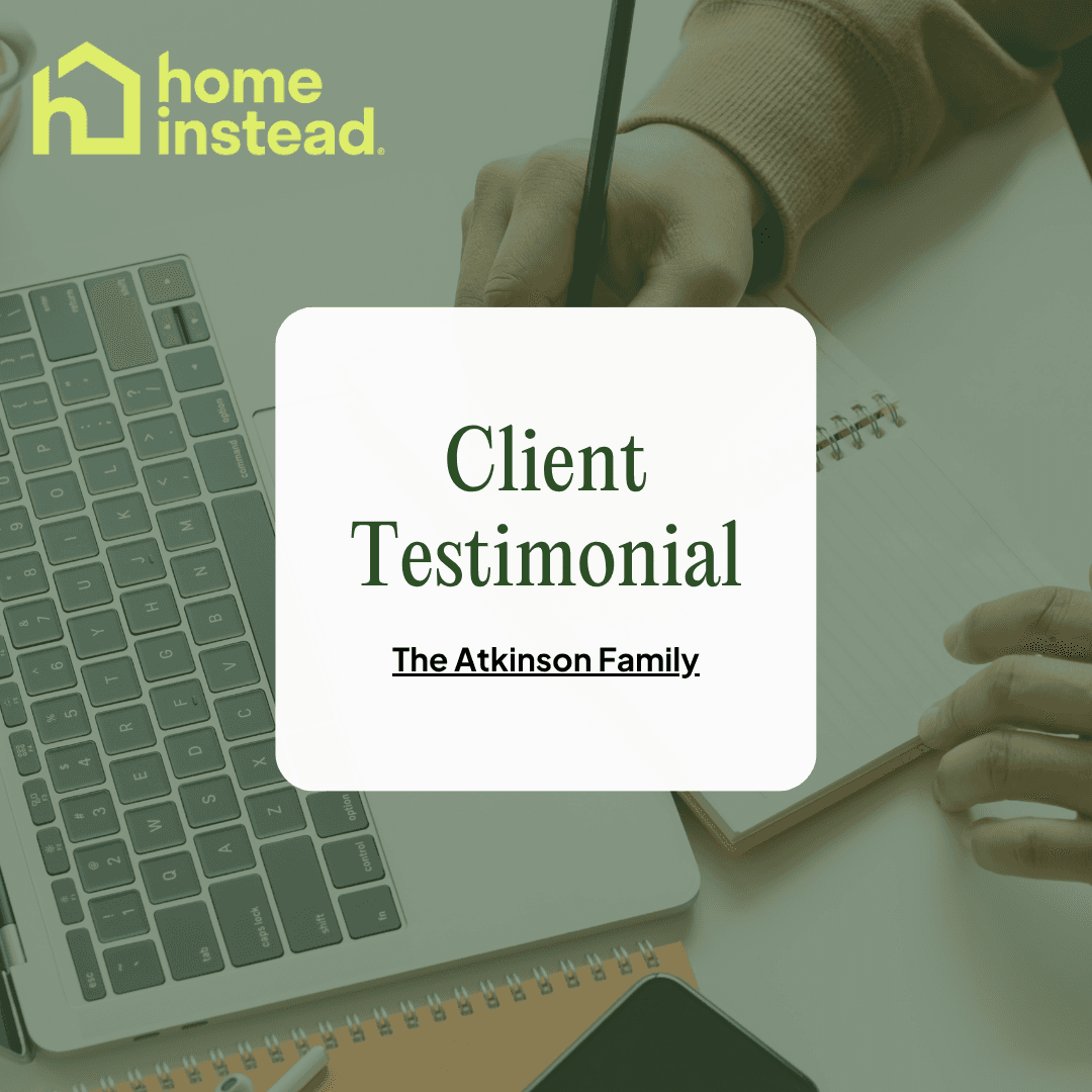 Hands writing in a notebook near a laptop, with "Client Testimonial: The Atkinson Family" text overlay. - Home Instead