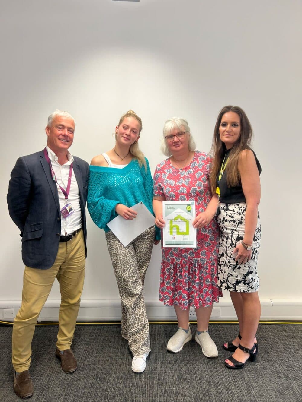 Care pros after receiving dementia training certificates , along with office team