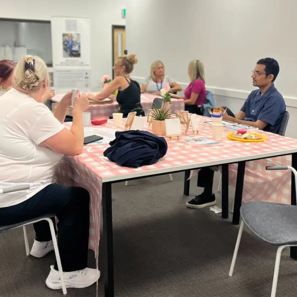 Visitors to the Home Instead Watford Memory Cafe talking and enjoying time together