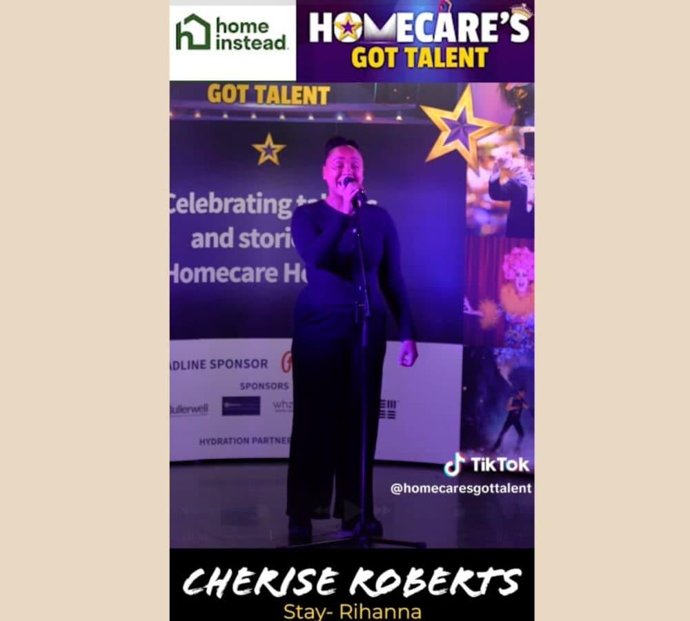 A woman standing and singing on stage